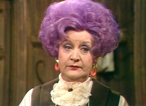 Molle Sugden as a Purple Haired Mrs. Slocombe